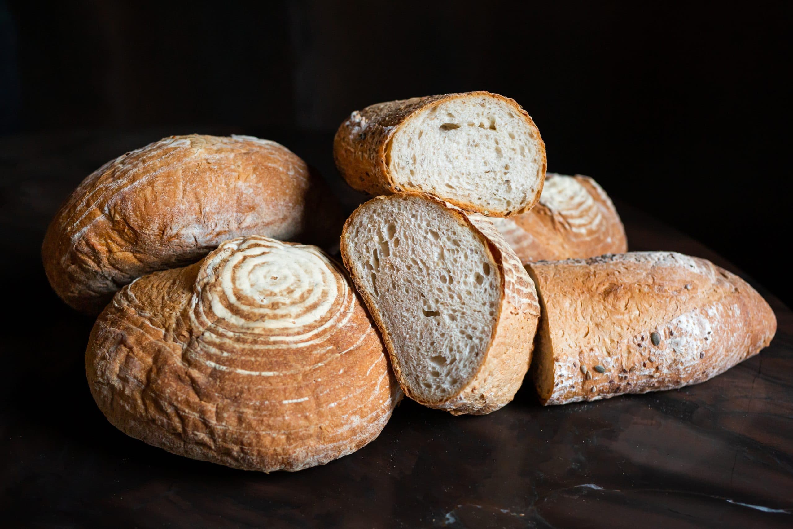Artisanal bread loaves on dark background